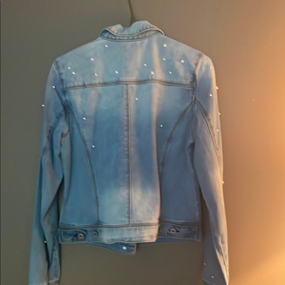 Brand new denim jacket with beautiful curls faceted to it Brand new with tags